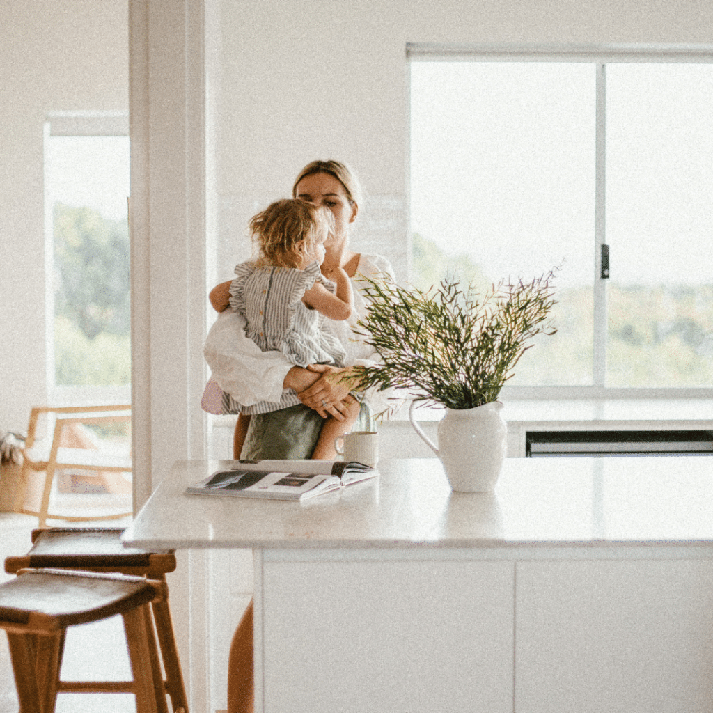 Hamelin Bay modular home kitchen woman holding child