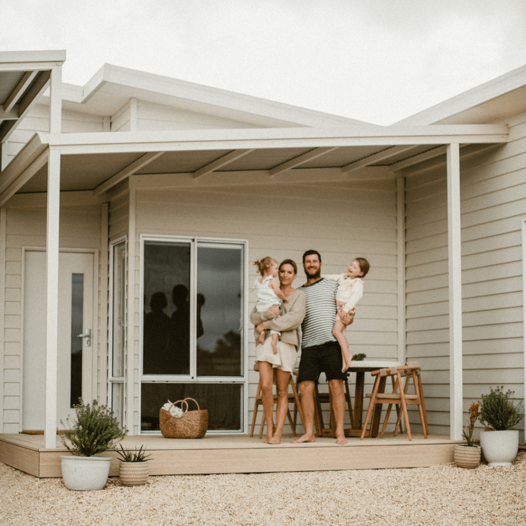 Family standing on the porch of their Hamelin Bay modular home